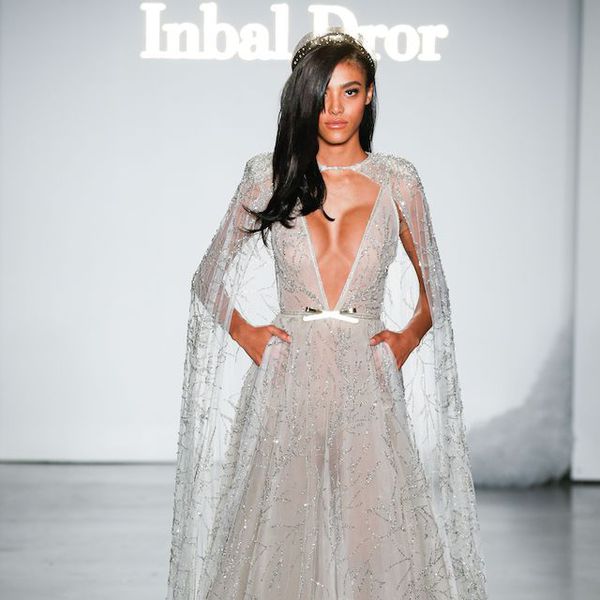 Model in plunging neckline wedding dress with cape