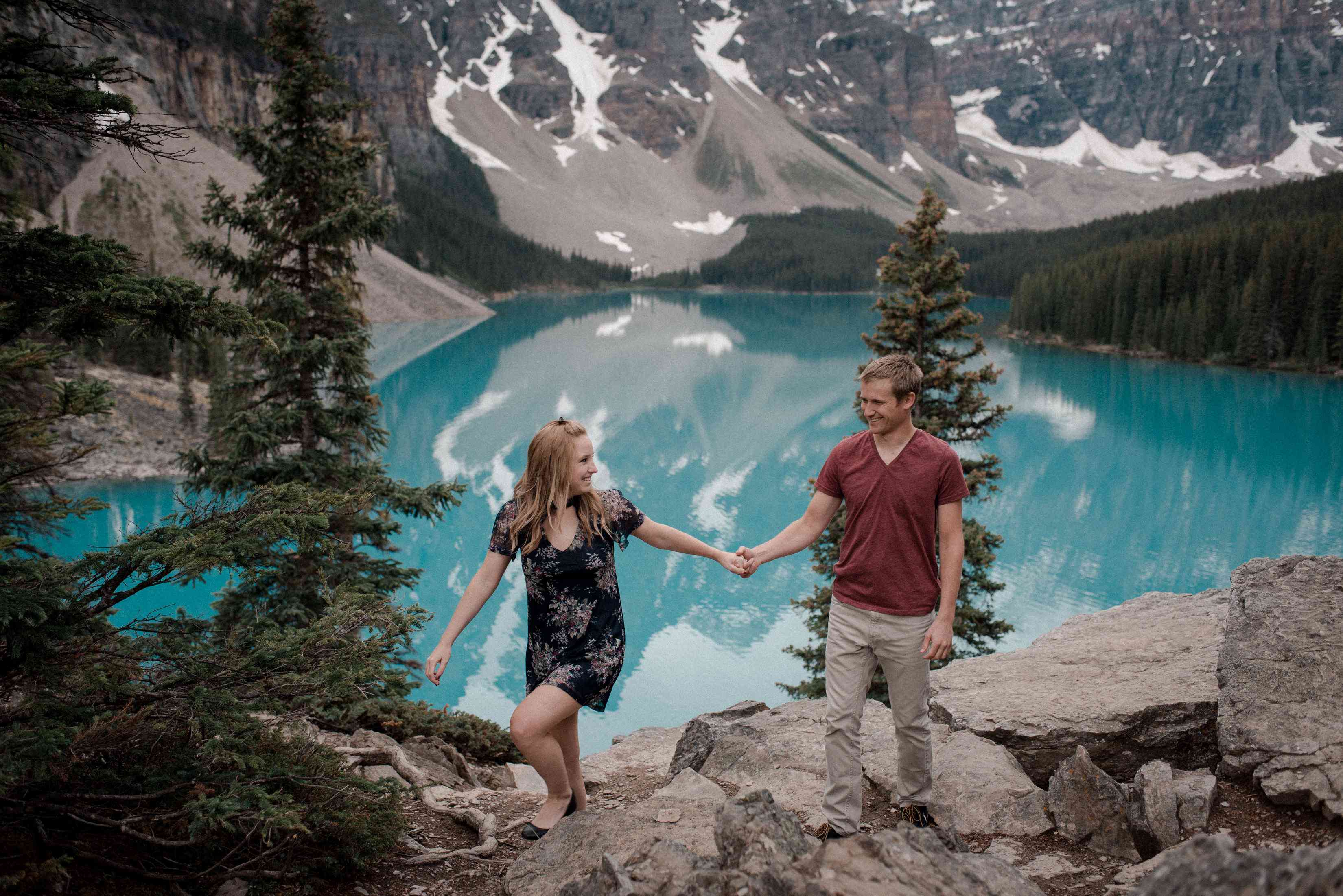 夫妇手牵着手，在背景绿松石湖