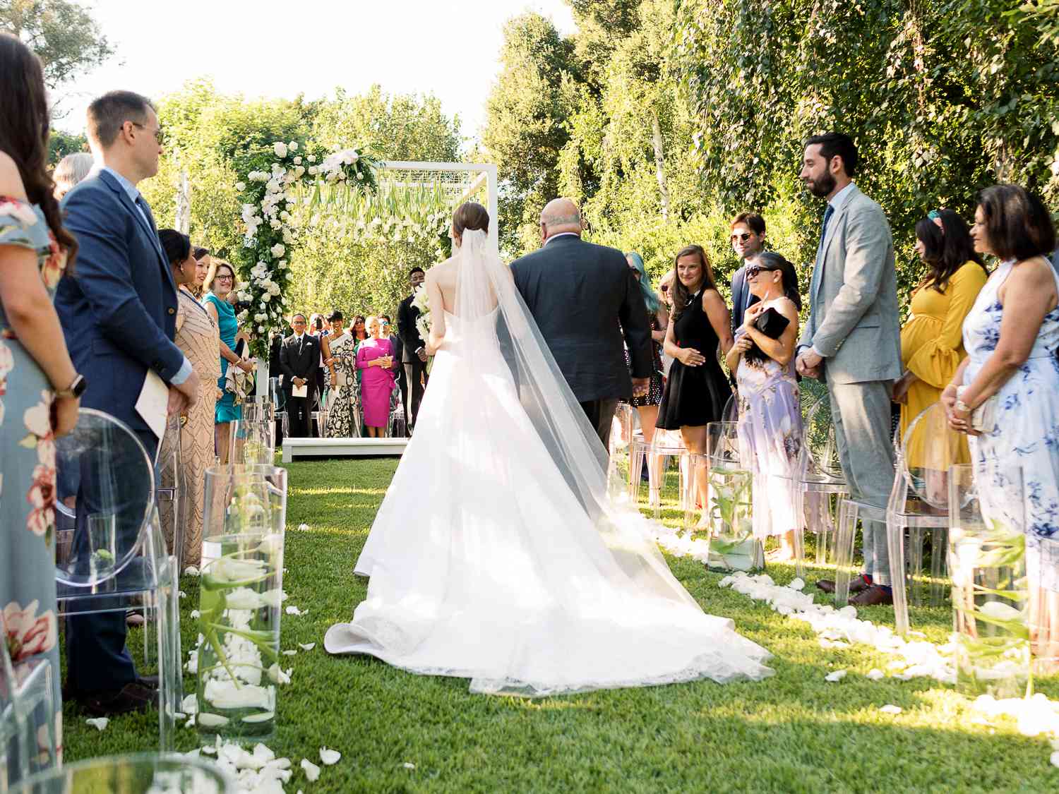 bride walking down aisle with father