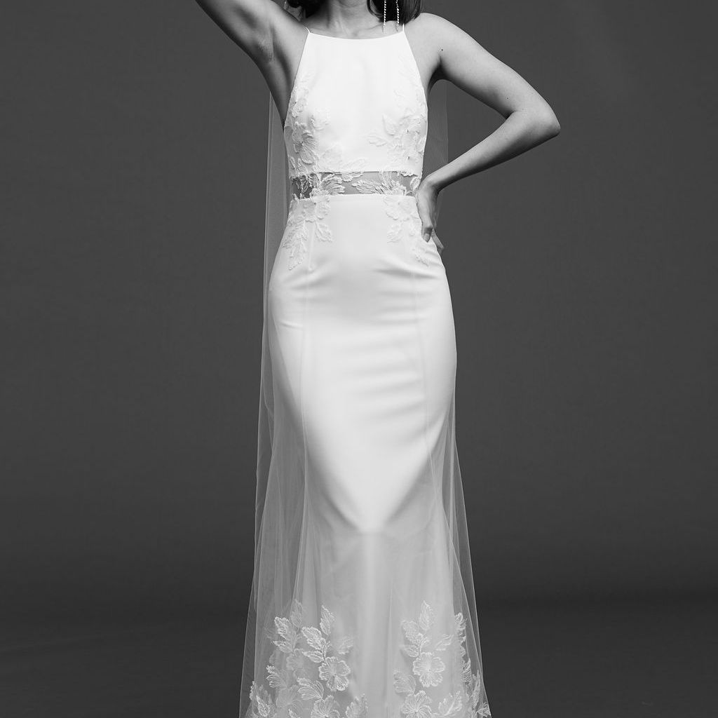 模特在绉纱连衣裙与绣花薄纱覆盖