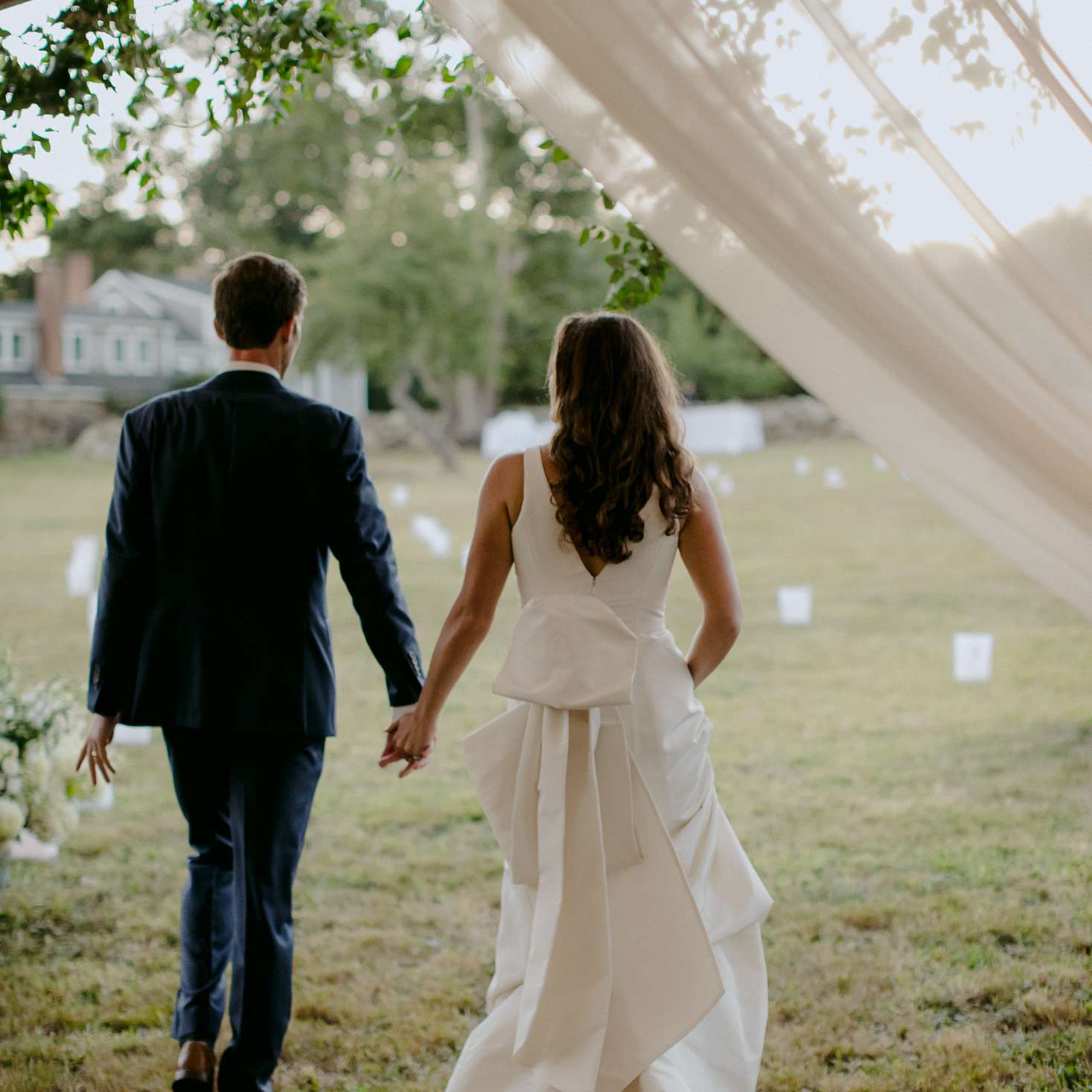 家庭乡村马萨诸塞州婚礼，新娘和新郎手牵手接待