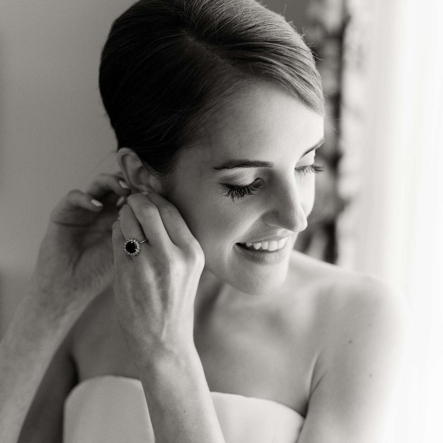 bride putting on earring