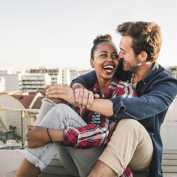 微笑和拥抱在屋顶的夫妇
