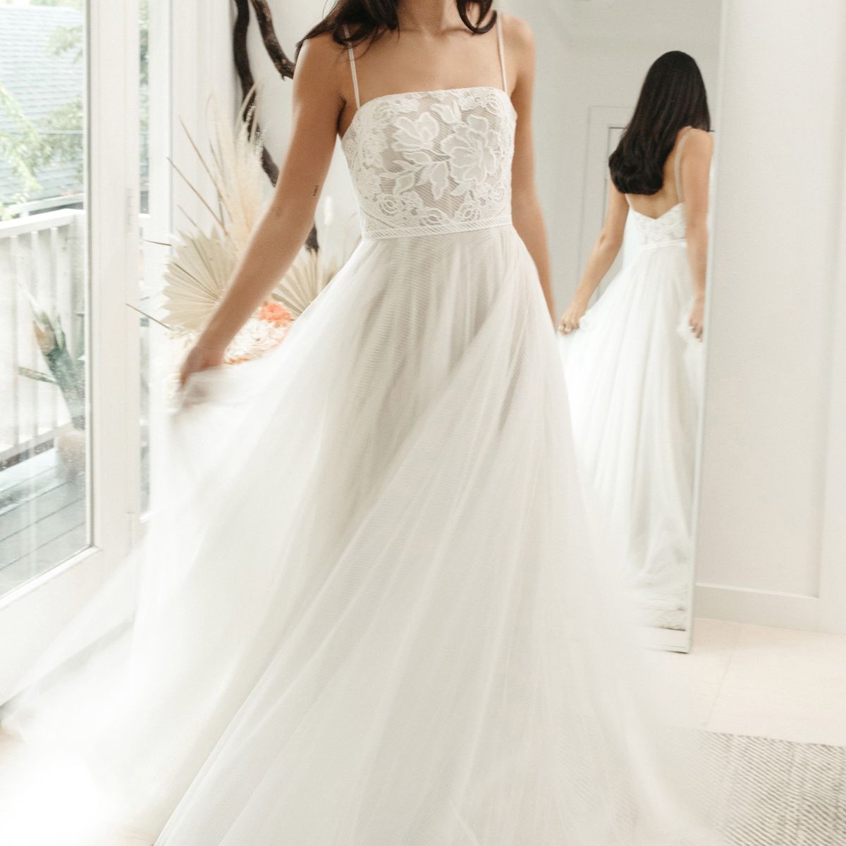 在一个无肩带的一条带蕾丝衣衫和薄纱裙的玻璃衣服的模型