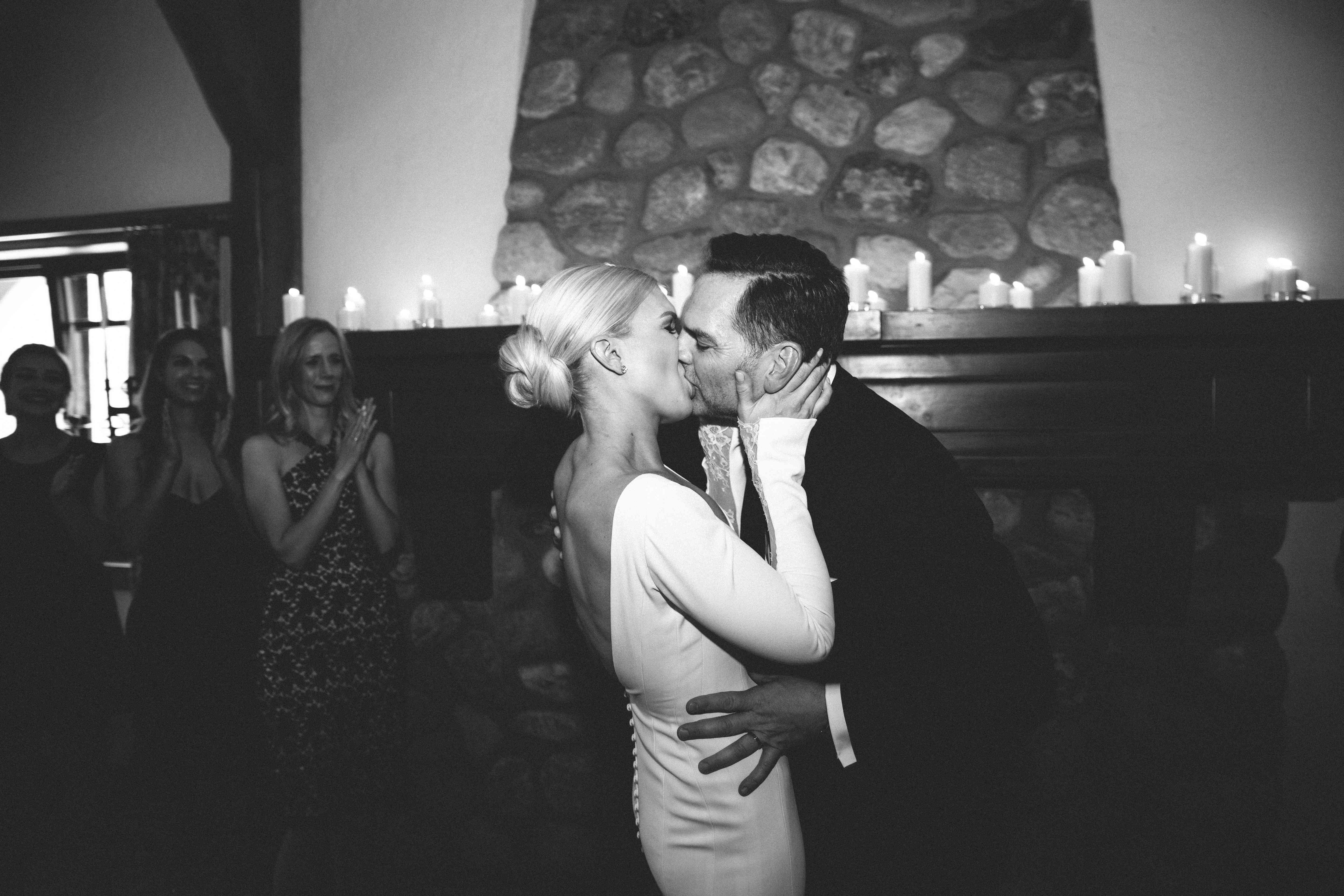 新娘和新郎在壁炉前接吻