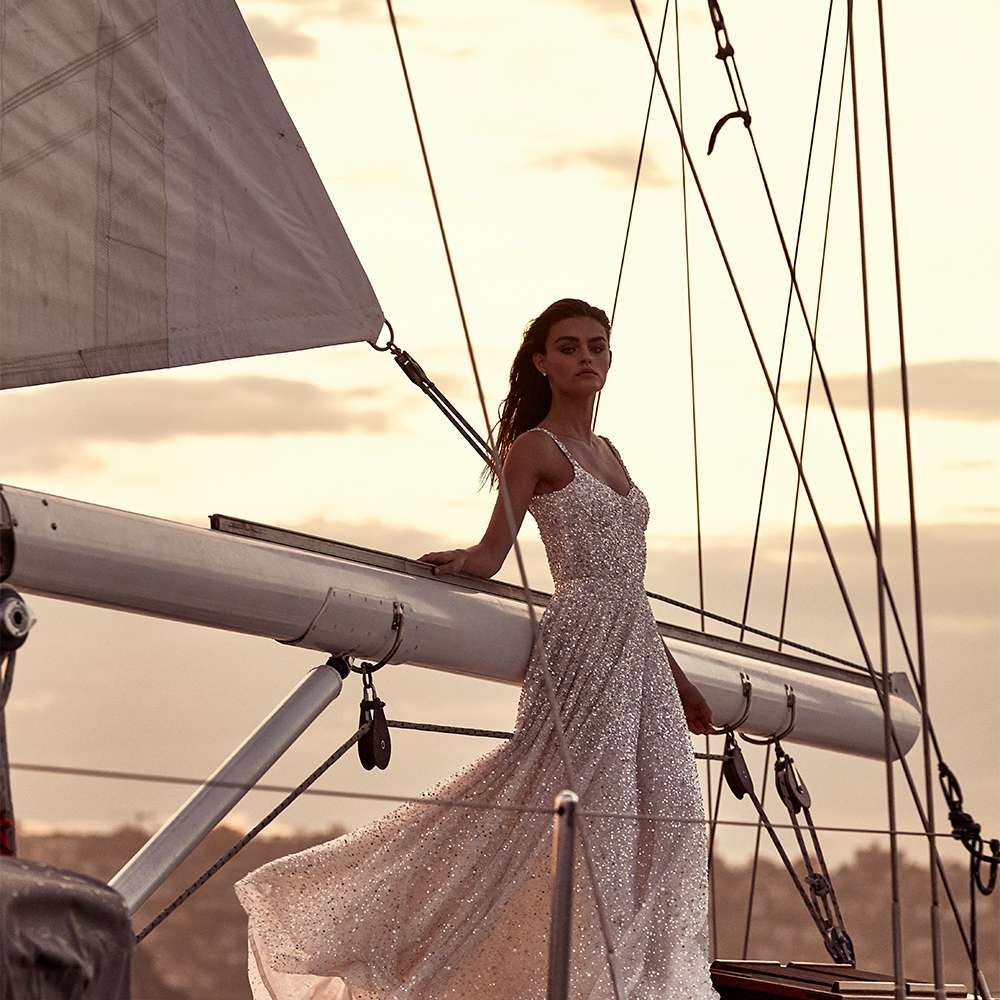 Bride in a silver glittery dress on a sail boat