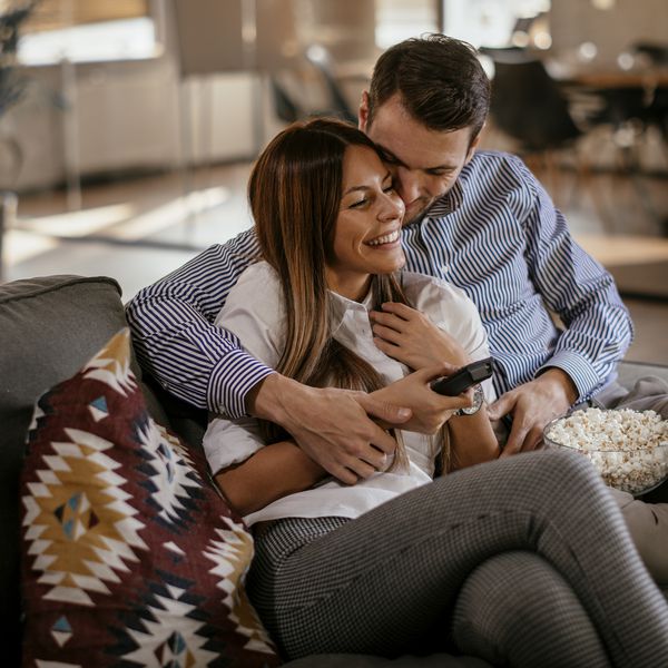 Man and woman hugging on couch